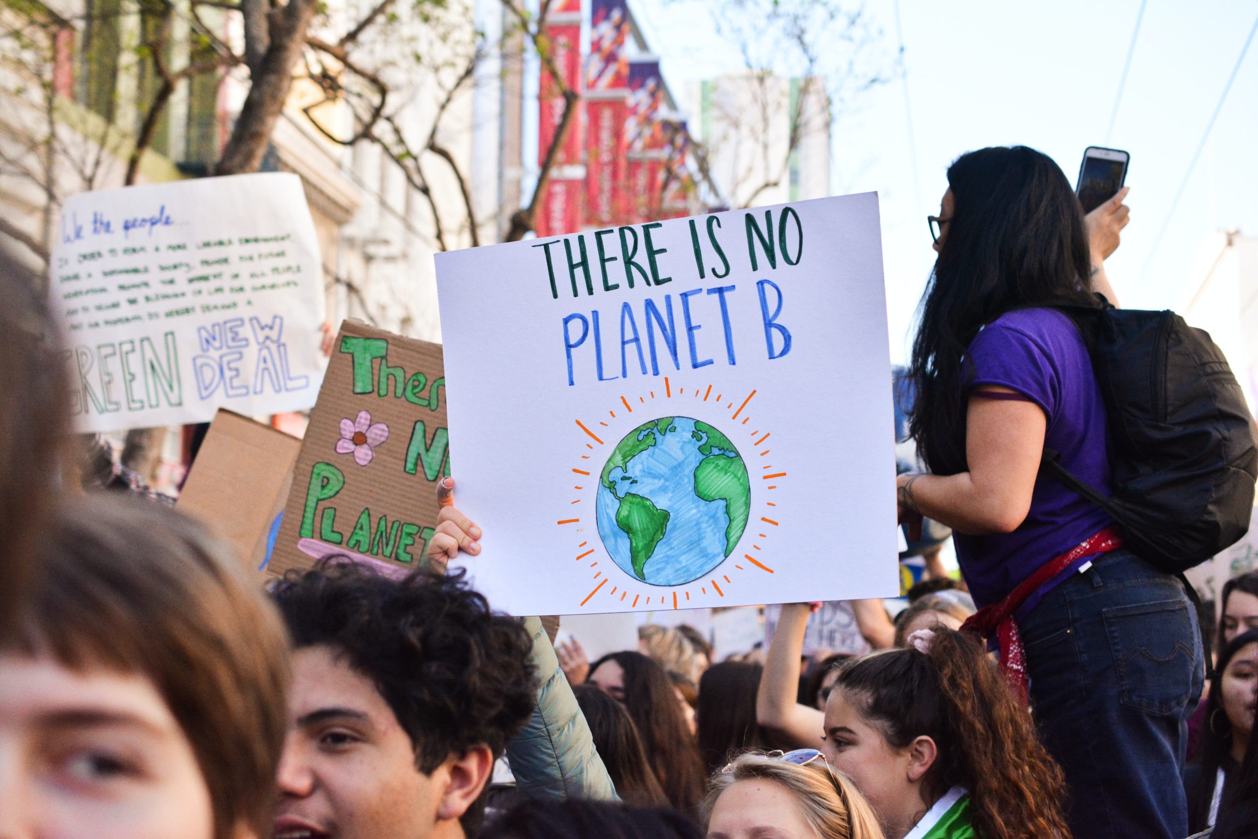 li-an-lim-ycW4YxhrWHM-unsplash people protesting with sign reading there is no planet B