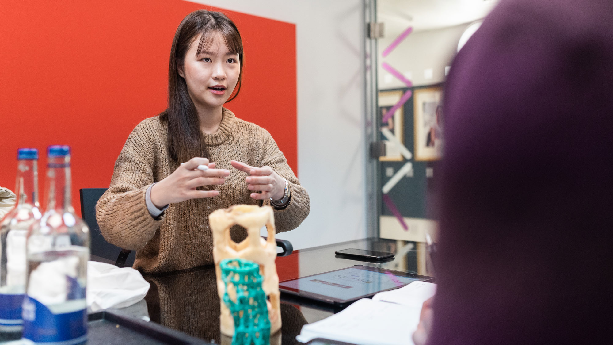 female-student-at-imperial-enterprise-lab-discussing-an-idea-and-gesturing-with-her-hands